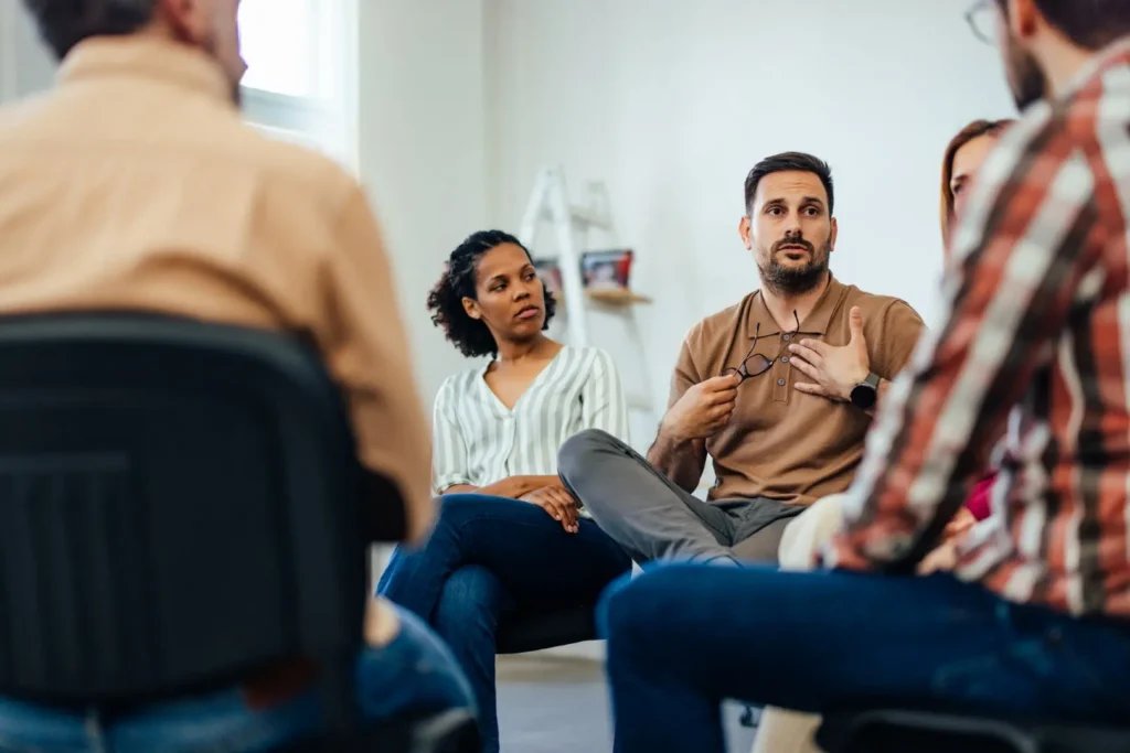 The Grove Recovery | diverse group engaged in a focused discussion in a 2026 03 20 05 45 37 utc