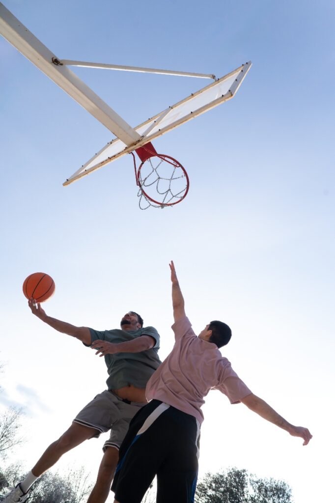 two men playing basketball in a mens rehab program in orange county.