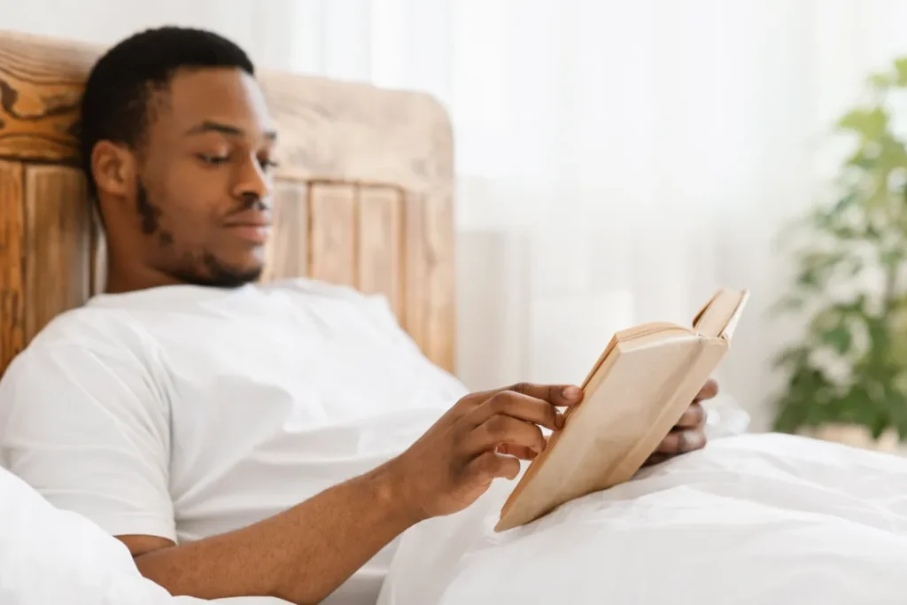 The Grove Recovery | man reading a book in natural light indoors