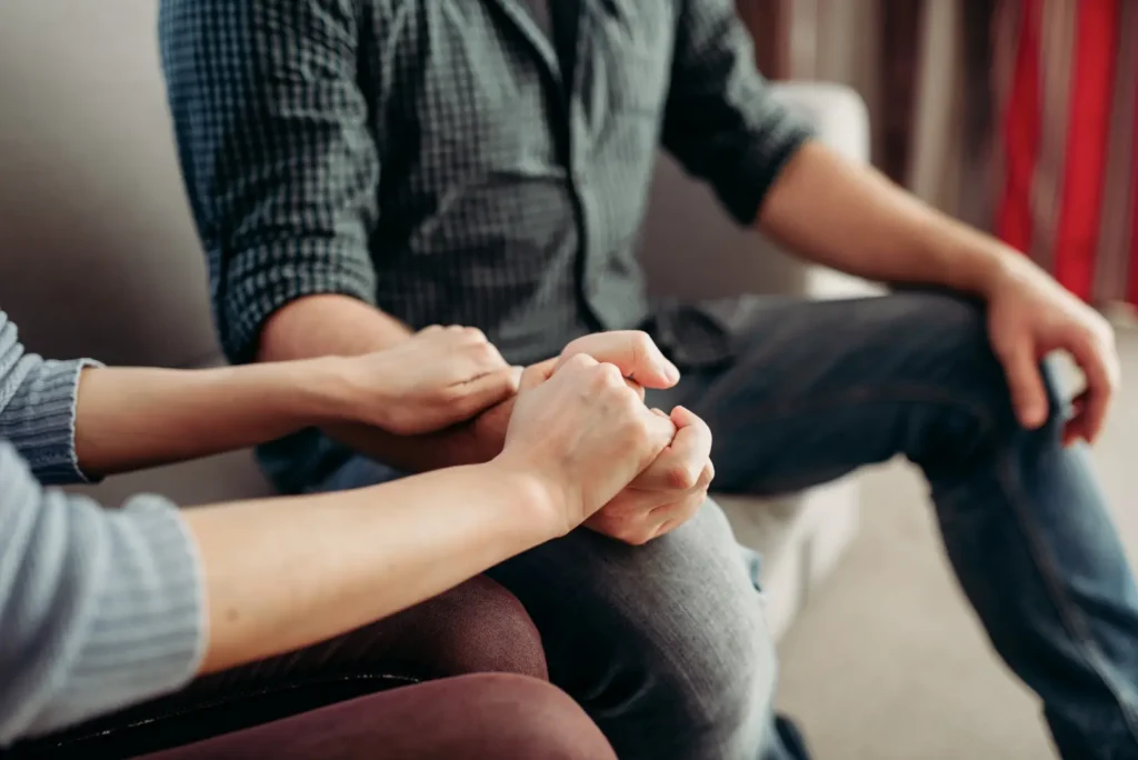 The Grove Recovery | couple holding hands on couch in home setting 2026 03 16 00 37 04 utc