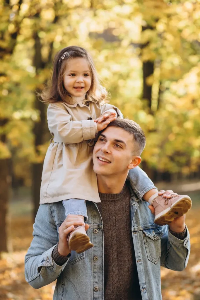 The Grove Recovery | father carries daughter on shoulders in autumn par 2026 01 08 02 06 30 utc